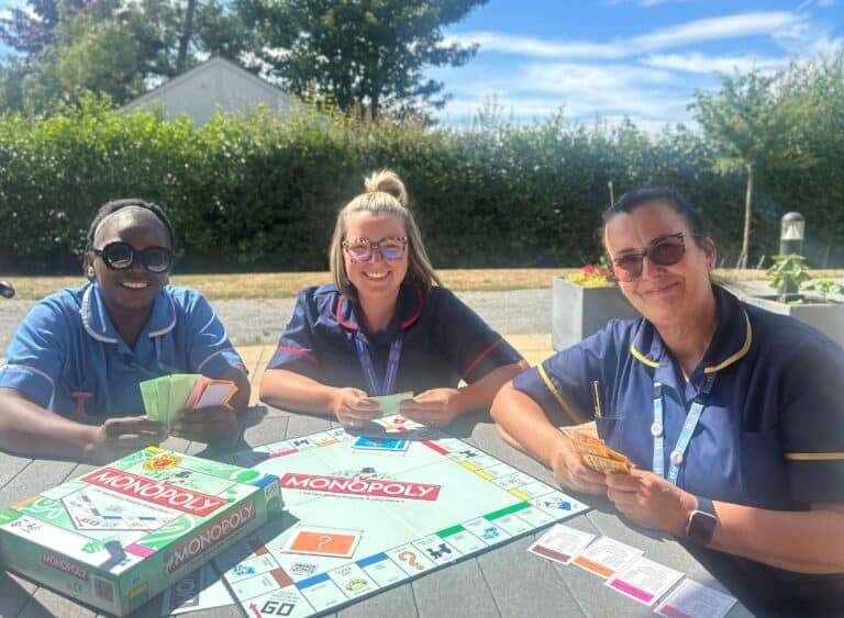 Nurse at Fair Havens with a Monopoly Board