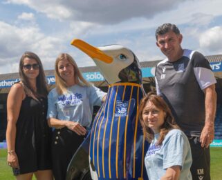 Codey from BTMK, Vanessa and Faye from Havens Hospices and Kevin, Southend United Football coach standing around Buddy the penguin/