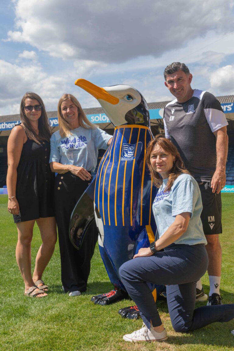 Codey from BTMK, Vanessa and Faye from Havens Hospices and Kevin, Southend United Football coach standing around Buddy the penguin/