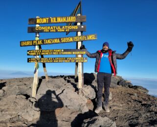 A man standing on the top of Kilimanjaro.