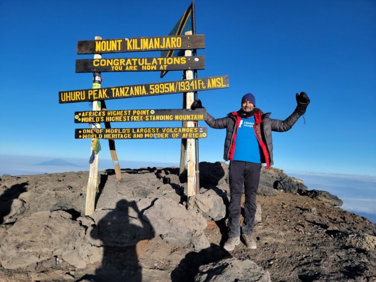 A man standing on the top of Kilimanjaro.