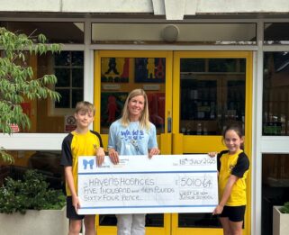 Vanessa from the Projects Team with students from West Leigh Junior School holding a cheque.