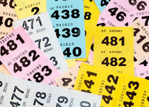 flat lay of yellow blue and pink raffle tickets