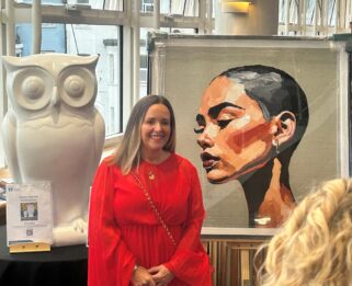 Zara Muse with her portrait donated to Little Havens at the Havens Hospices Gala Ball