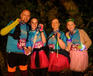 a group of eventers smiling holding medal looking at camera