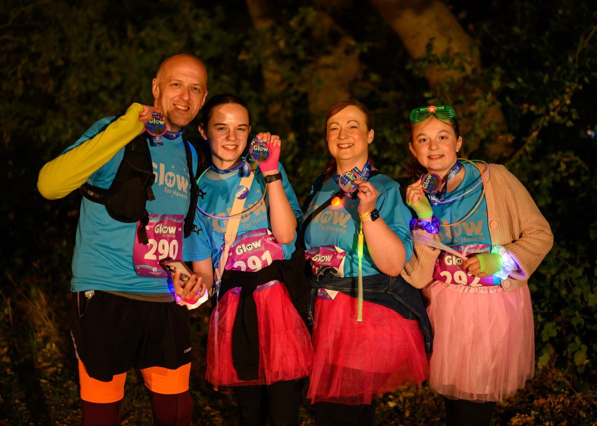 a group of eventers smiling holding medal looking at camera