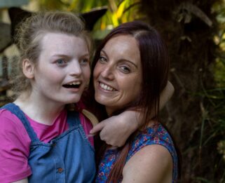 Young girl hugging her mum in Little Havens gardens