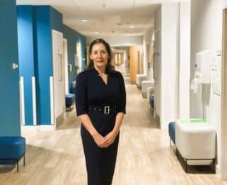 Louise Bryan standing in hospice corridor