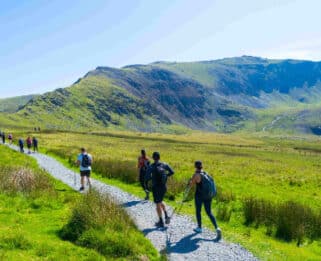 Hikers walking through Welsh countryside
