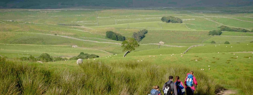 Trekkers walking through the Yorkshire Three Peaks