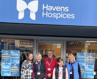 5 Havens Hospices volunteers and staff standing outside the shop front on Kings Street