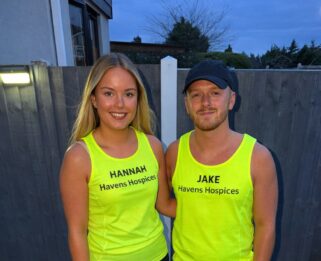Two runners stood wearing yellow havens running vests
