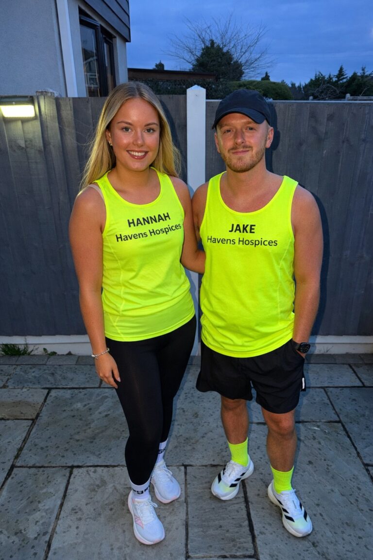 Two runners stood wearing yellow havens running vests