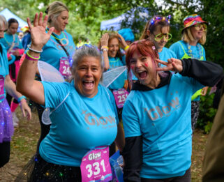 Two women dressed in neon clothes at the Glow for Havens event.