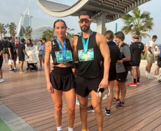 Man and women posing with their medal at Dubai Marathon