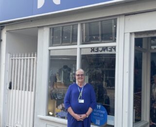 Linda, Assistant Shop Manager standing outside of the Southend Havens Hospice charity shop.