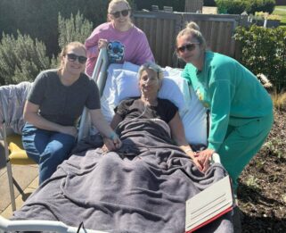 Zara surrounded by her daughters in the garden at Fair Havens