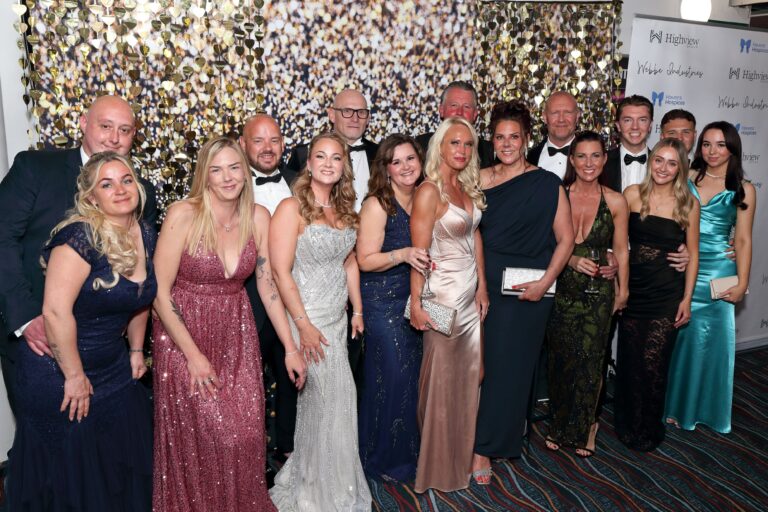 Group photo of men and women in black tie.