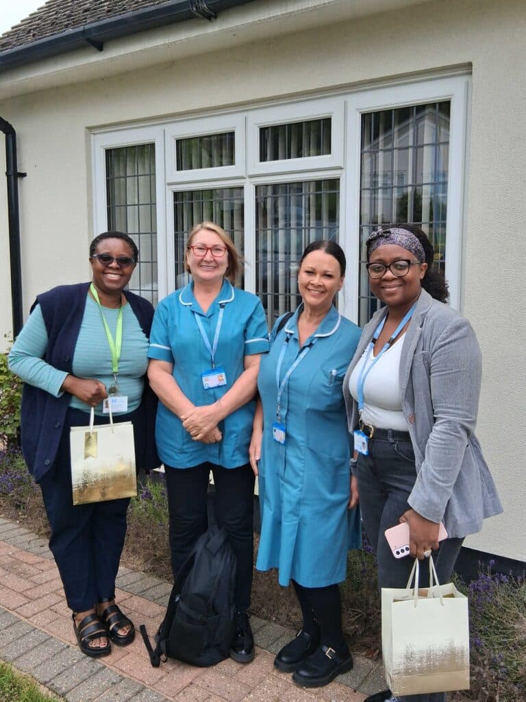 Blessing and Bea with two healthcare assistants in the community