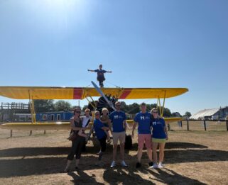 Group of men and women in front of Wing Walk plane