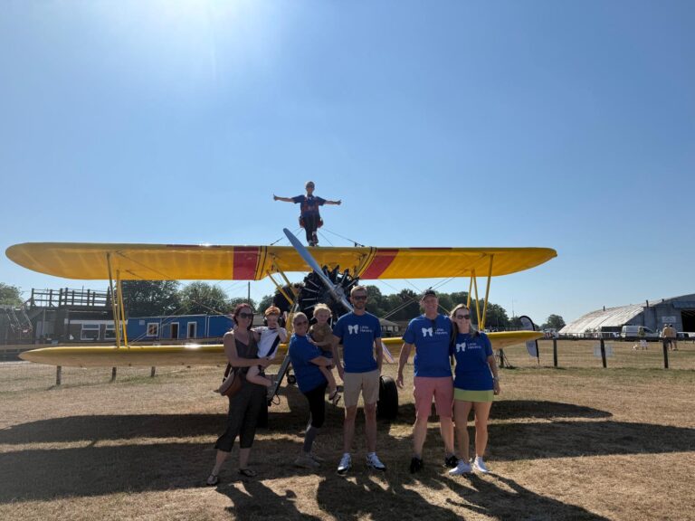 Group of men and women in front of Wing Walk plane