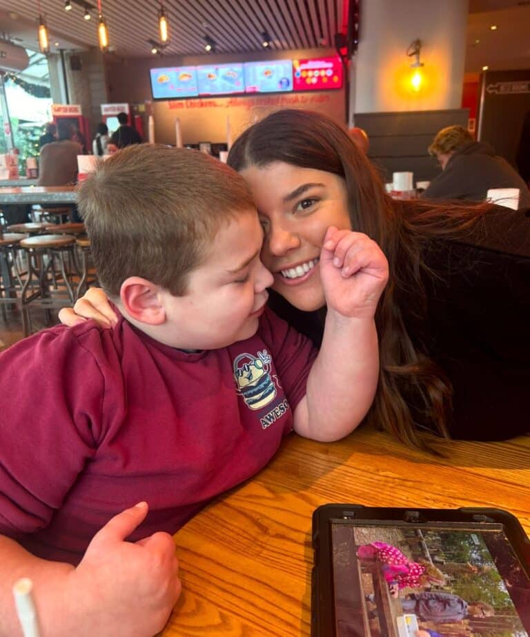 Young boy and his mum smiling in a resturant