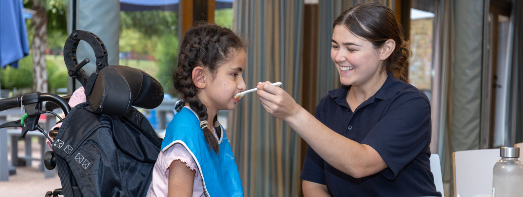 Isabella at dinner time with Nurse Lucy