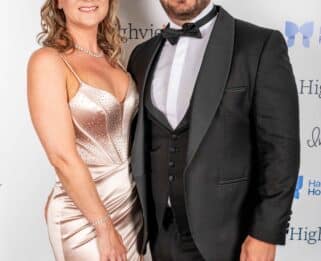A man and a woman in black tie attire