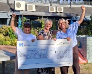 Supporters, Claire and Lisa standing with a cheque made out to Havens Hospices for £100,000, along with Lucy, fundraiser for Havens Hospices