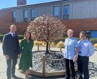 Martin Stibbards, Louise Bryan, Debbie from the Care Team and Steve from Fundraising Team beside the Leaves of Life Tree outside Fair Havens