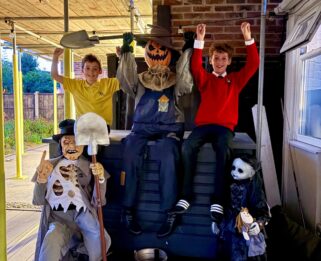 Two boys posing with Halloween decorations