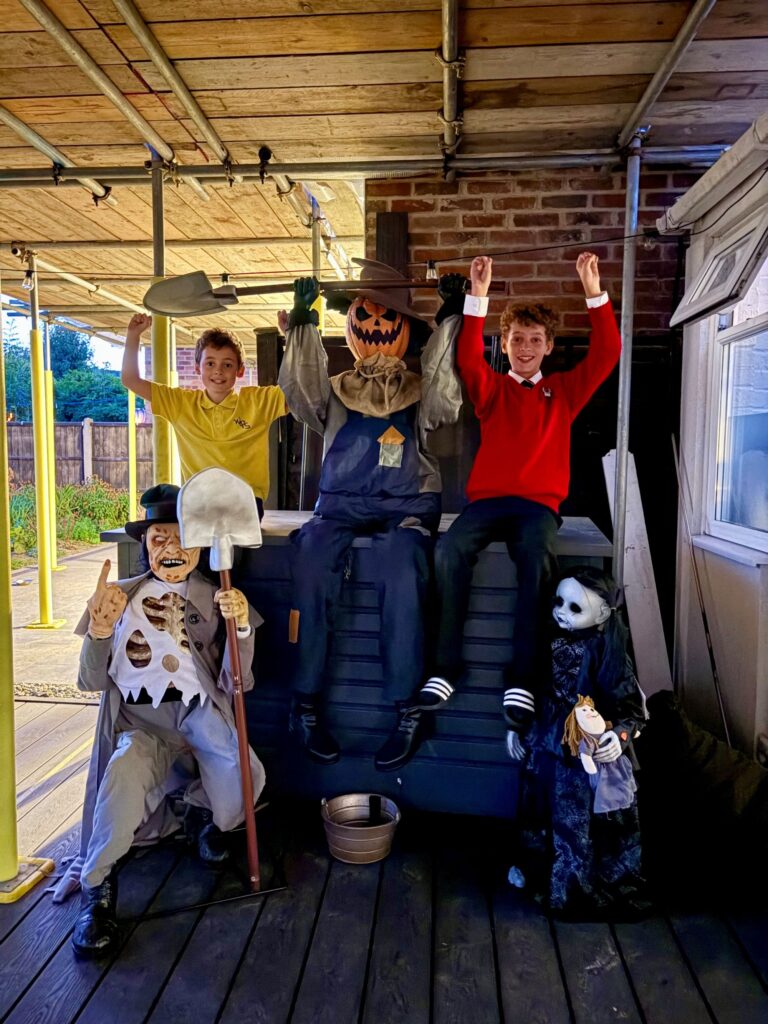 Two boys posing with Halloween decorations